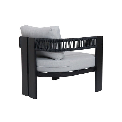 Modern armchair from the Sorrelle 5 Seater Wicker Outdoor Sofa Set in Black, featuring a black frame, light-gray cushions, and black rope detailing for a sleek indoor-outdoor look.