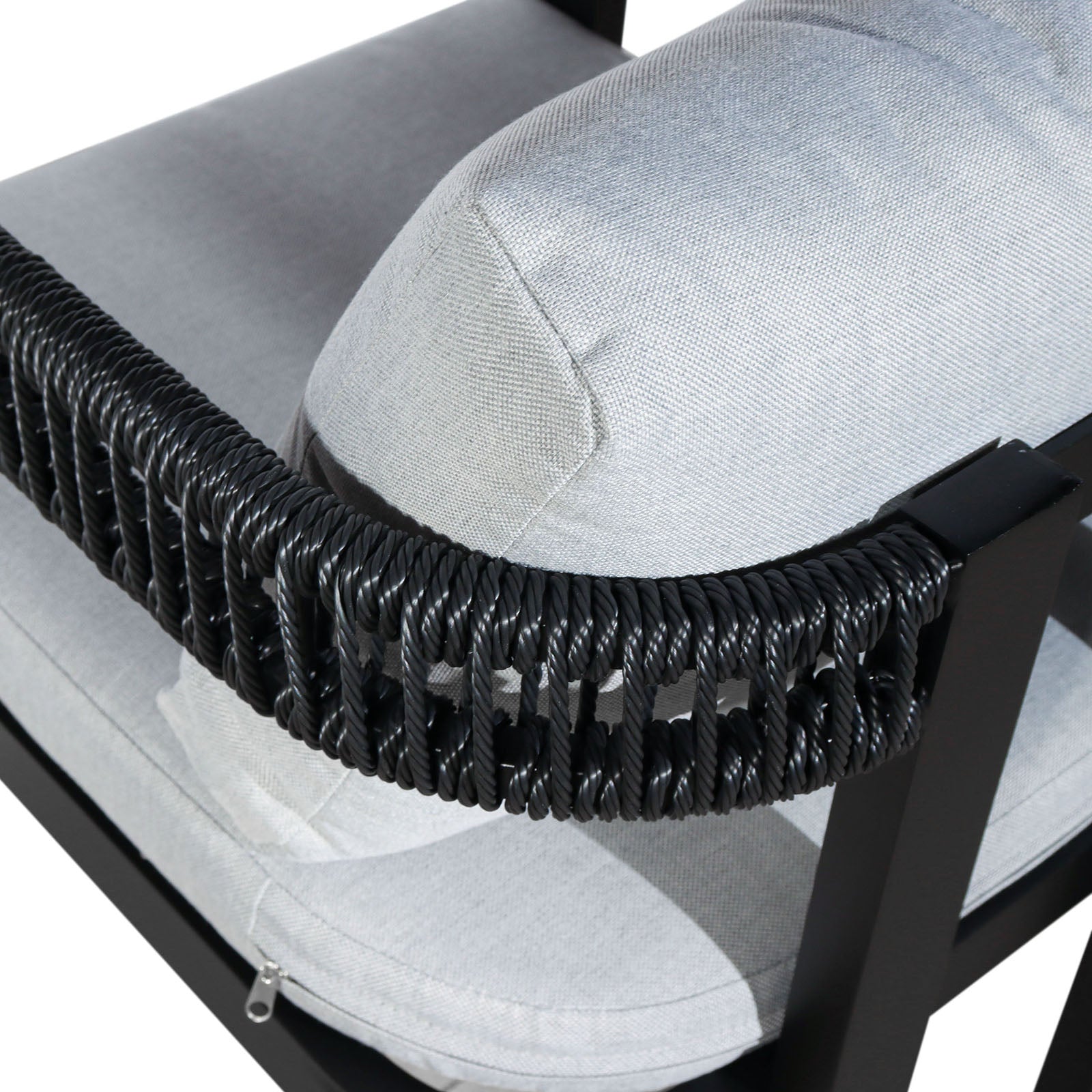 Close-up of the Tavari 6-Seater Aluminium Outdoor Dining Set in Black, highlighting the light-gray upholstered cushion with a visible zipper set into a black metal frame, accented by twisted black synthetic rope.