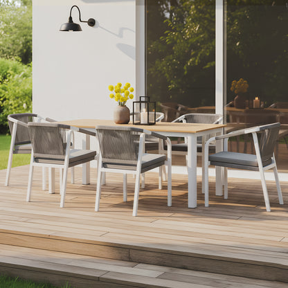 7-piece outdoor dining set with a timber-top table and six white aluminum chairs featuring grey rope-woven backs and charcoal cushions.