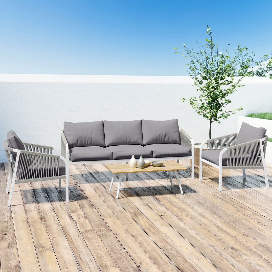 Vernon 5 Seater Aluminium Outdoor Sofa Set in Grey on a wood deck, includes a three-seater sofa, two armchairs, and a coffee table with decorative items, enhancing an elegant patio setup.