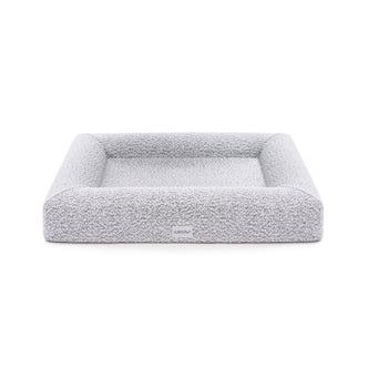 Close-up of Tyro Luxe Medium Orthopedic Pet Bed featuring a textured boucle cover, showcasing its plush, supportive surface designed for medium-sized pets, with visible memory foam contours for joint support.