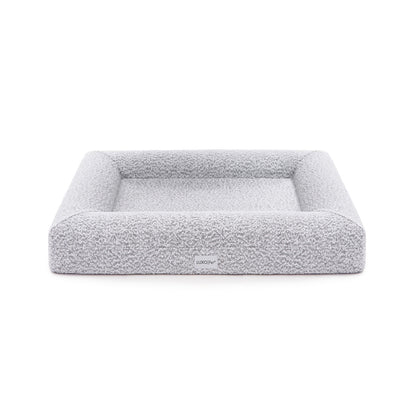 Close-up of Tyro Luxe Medium Orthopedic Pet Bed featuring a textured boucle cover, showcasing its plush, supportive surface designed for medium-sized pets, with visible memory foam contours for joint support.