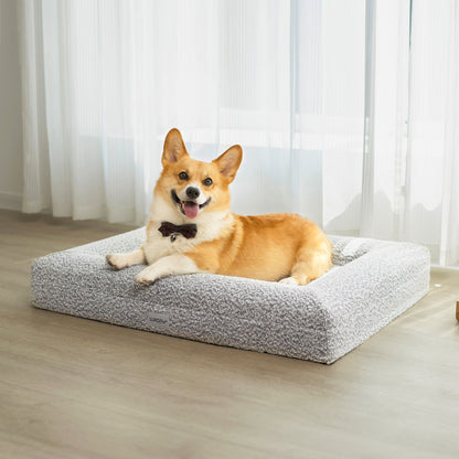 Tyro Luxe Medium Orthopedic Pet Bed with textured boucle cover, shown in a close-up with a dog wearing a bow tie, illustrating comfort and style ideal for medium-sized pets.