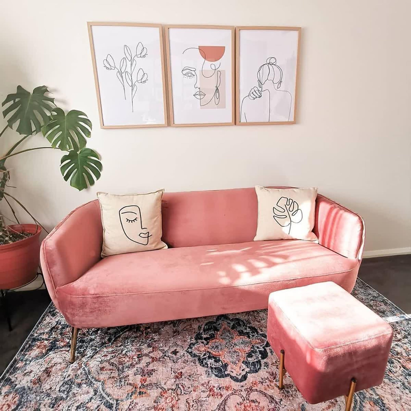 Ariza 200cmx300cm Large Persian Silky Indoor Floor Rug with a distressed floral pattern in beige tones, placed under a pink-velvet sofa and matching ottoman, enhancing the cozy living-room vignette.
