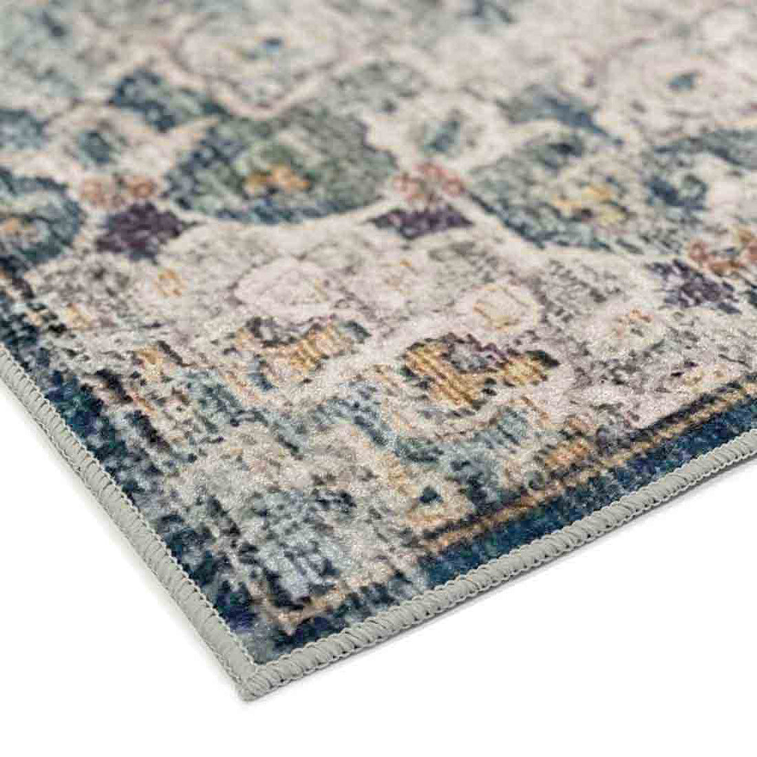 Close-up of Ariza 200cmx300cm Large Persian Silky Indoor Floor Rug, showcasing its over-locked edge and distressed ornamental pattern with muted tones, exemplifying its vintage, Persian-inspired design.