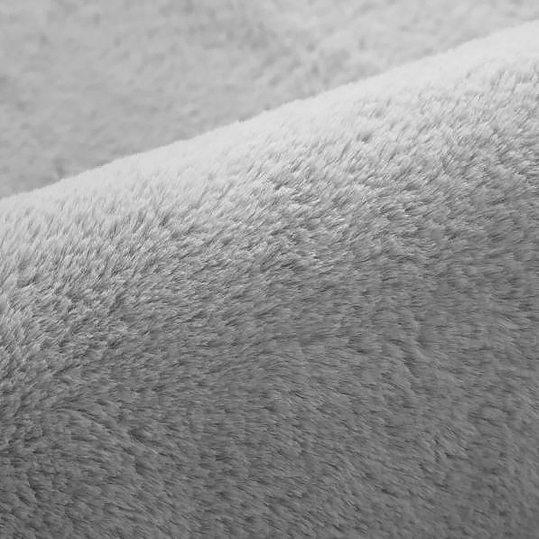 Close-up of Azaliya Silver Faux Rabbit Fur Rug 120x180cm, showcasing its soft, short-pile fabric. The plush texture enhances luxury and comfort, ideal for contemporary and modern indoor spaces.