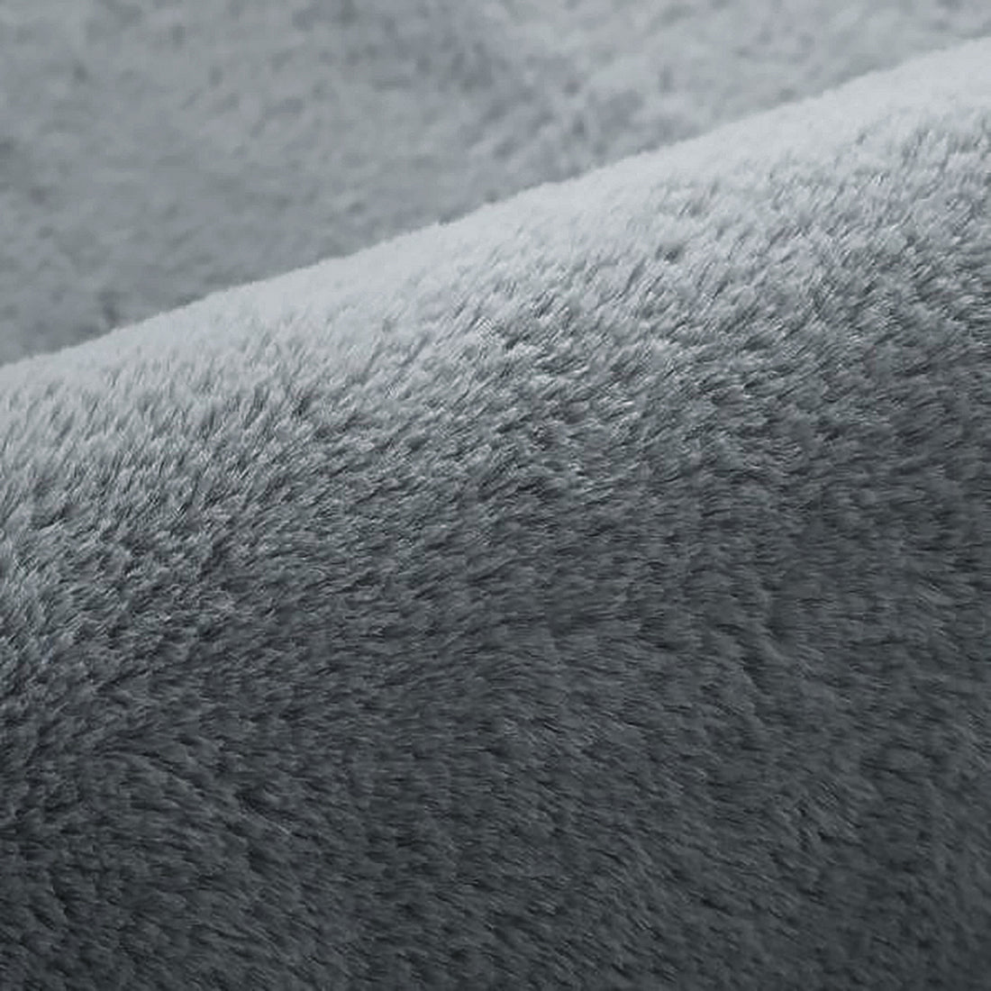 Close-up of Azaliya Dark Grey Faux Rabbit Fur Rug 200x300cm, showcasing its plush, fuzzy texture resembling soft fleece, ideal for adding luxurious comfort to modern or minimalist interiors.