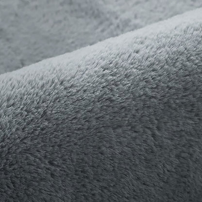 Close-up of Azaliya Dark Grey Faux Rabbit Fur Rug 200x300cm, showcasing its plush, fuzzy texture resembling soft fleece, ideal for adding luxurious comfort to modern or minimalist interiors.