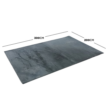 Azaliya Dark Grey Faux Rabbit Fur Rug 200x300cm, a plush shag-style rug, shown laid flat at an angle, highlighting its soft texture and rectangular shape, perfect for modern and contemporary interiors.