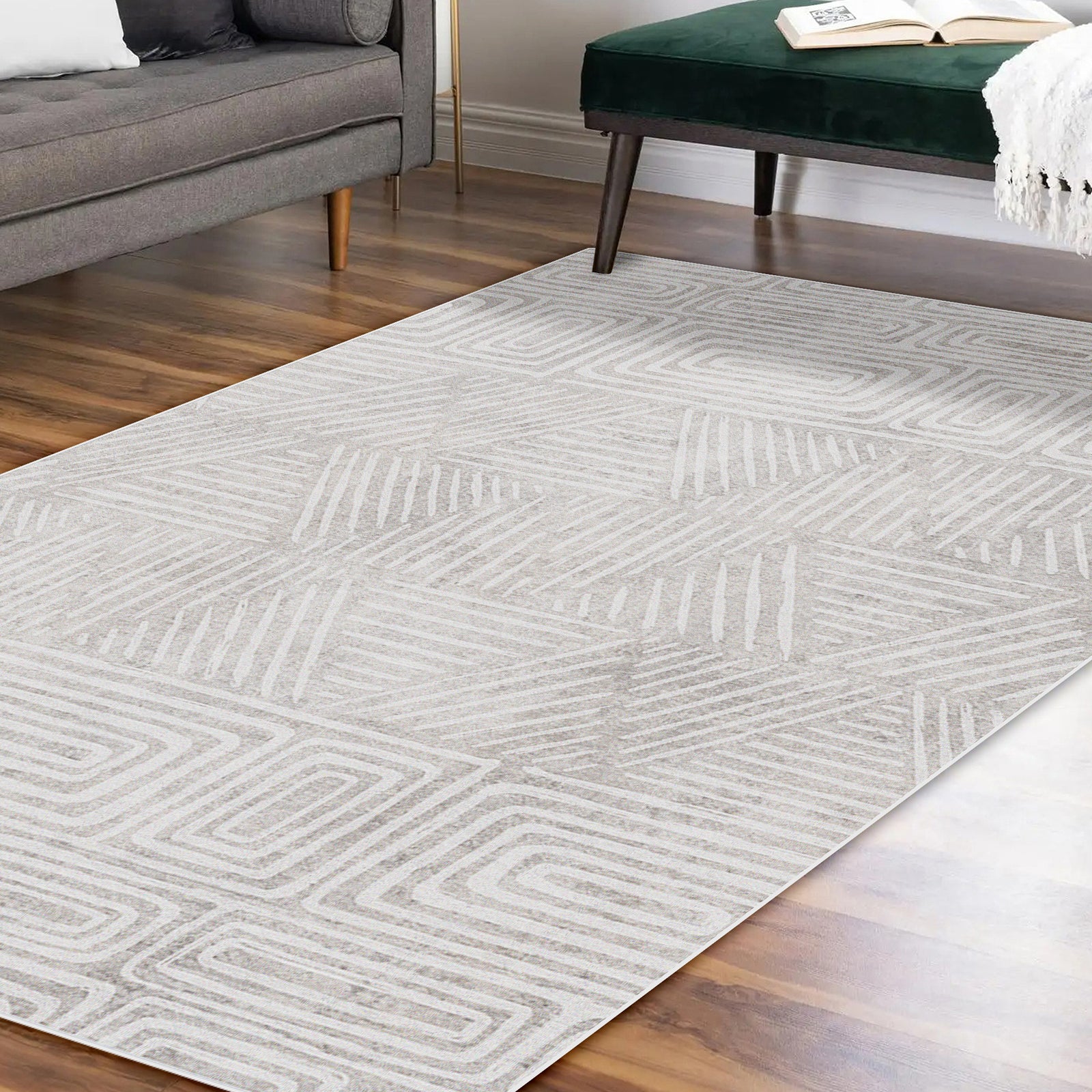 Duved 200x300cm Large Contemporary Indoor Floor Rug on hardwood flooring, featuring a geometric pattern. Partially shown: gray sofa, dark green bench with white throw, and an open book.