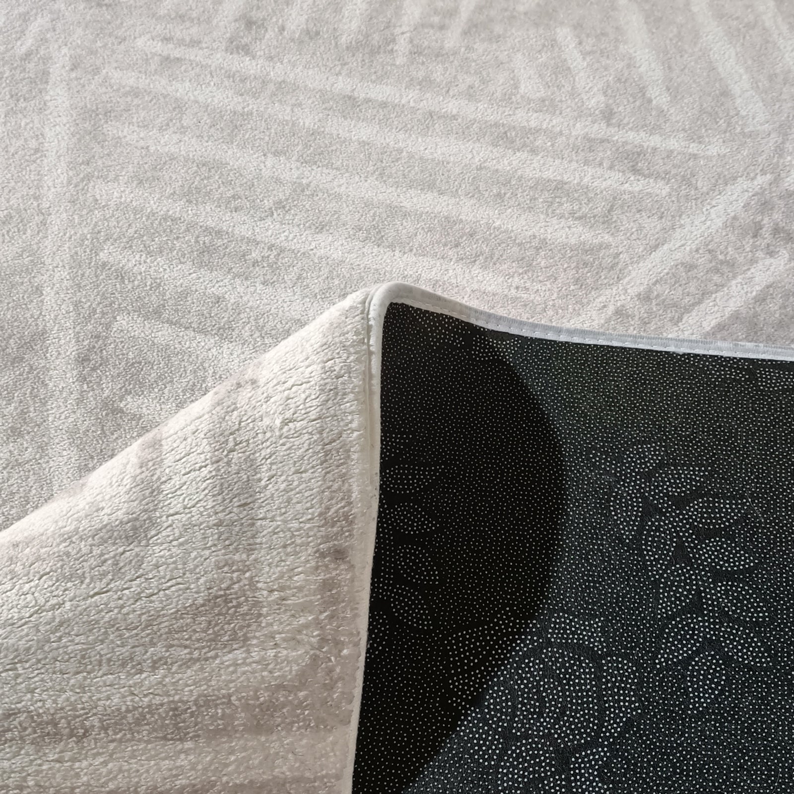 Duved 200x300cm Large Contemporary Indoor Floor Rug with light-grey terry-cloth appearance, flipped corner showing black dotted anti-slip backing, ideal for modern interiors with a plush feel.