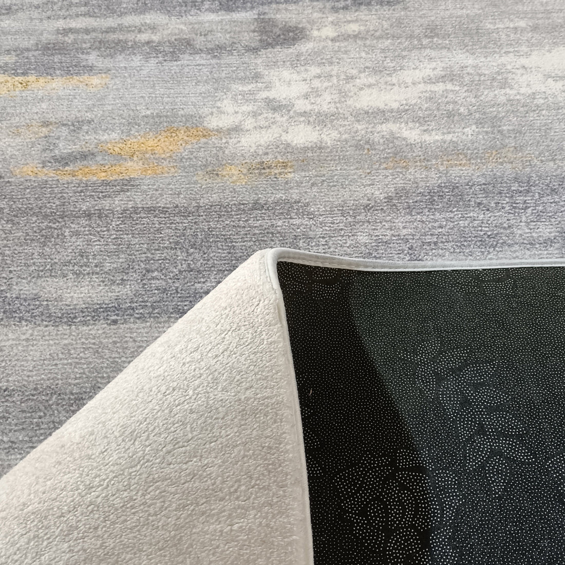Getbo 200x300cm Large Modern Indoor Floor Rug, featuring a muted abstract design with a flipped corner revealing anti-slip backing, perfect for adding a touch of luxury and style to any space.