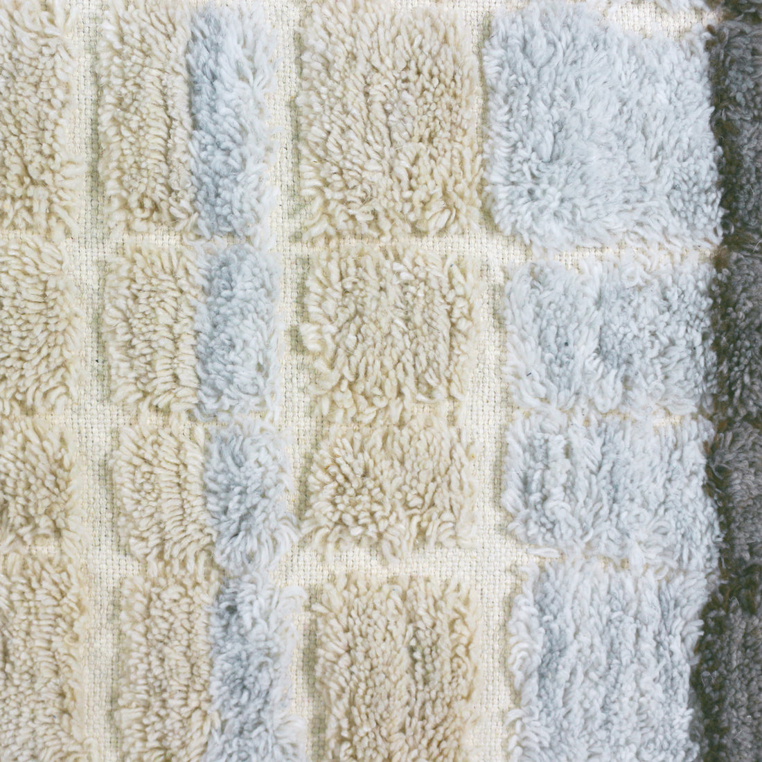 Isaac 200x300cm Abstract Wool Blend Handwoven Shag Rug features a tufted, shaggy-pile with a subtle checkerboard pattern of soft, curly fibers in neutral shades, showcasing its intricate texture and craftsmanship.