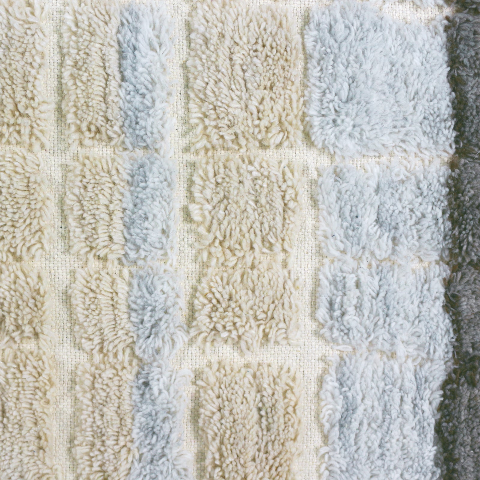 Isaac 200x300cm Abstract Wool Blend Handwoven Shag Rug features a tufted, shaggy-pile with a subtle checkerboard pattern of soft, curly fibers in neutral shades, showcasing its intricate texture and craftsmanship.