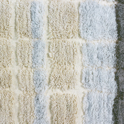 Isaac 200x300cm Abstract Wool Blend Handwoven Shag Rug features a tufted, shaggy-pile with a subtle checkerboard pattern of soft, curly fibers in neutral shades, showcasing its intricate texture and craftsmanship.