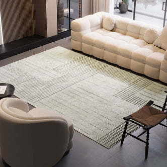 Jabeza Soft Contemporary Printed Rug 200x300cm displayed in a cozy living room setting, placed beneath a studio couch and furniture, highlighting its soft pile and modern design.
