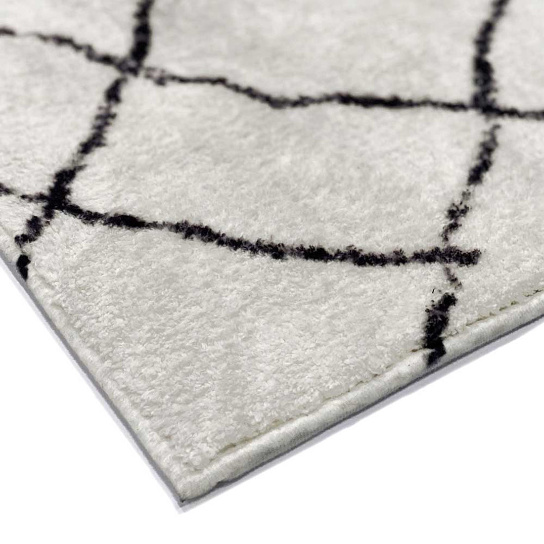 Close-up of the Melody Black & White Modern Rug 160x230cm, displaying black abstract lines on ivory, showcasing its Scandinavian-inspired design and soft texture, ideal for high-traffic areas.