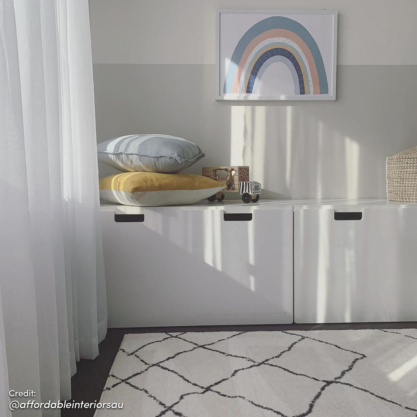 Melody Black and White Modern Floor Rug 200 x 300cm lies on the floor, featuring a subtle black-line diamond pattern on an ivory backdrop, complementing the minimalist playroom's decor.