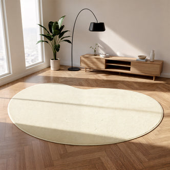 Parna 200x300cm Curved Large Soft Rug in Beige on herringbone floor, adding warmth; complements mid-century console, arcing lamp, and houseplant, creating a serene, Scandinavian-inspired living space.