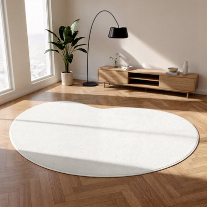 Parna 200 x 300cm Curved Soft Rug in Cream White on herringbone floor, complemented by light-wood console, decorative items, arched lamp, and houseplant, enhancing the bright, minimalist living room corner.