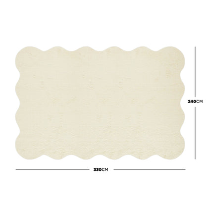 Pixie 240x330cm Wavy Large Shag Rug in Beige, featuring a cream-coloured surface with scalloped edges, plush 12mm high pile, and anti-slip backing, ideal for enhancing medium to large room décors.
