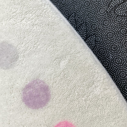 Shirin 160 Round Polka Dot Kids Indoor Rug features a white, fluffy surface with pastel polka dots and a black non-slip backing with white grip-dots, offering playful design and safety.