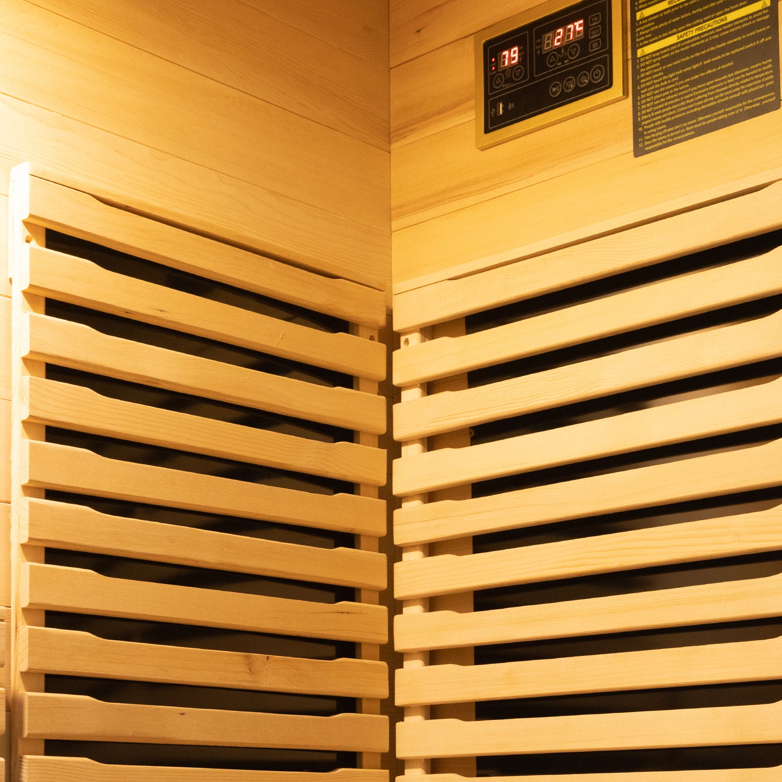 Harlow 1 Person Canadian Hemlock Infrared Home Sauna featuring light wooden slats, digital control panel with safety label, showcasing compact design and infrared heating elements.