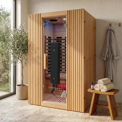 Wooden sauna cabin installed in a modern room with spa-style decor.