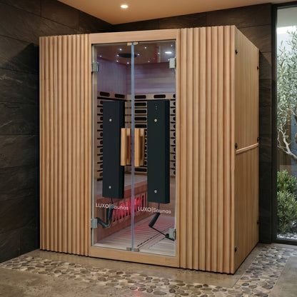 Wooden infrared sauna cabin installed in a modern spa-like room