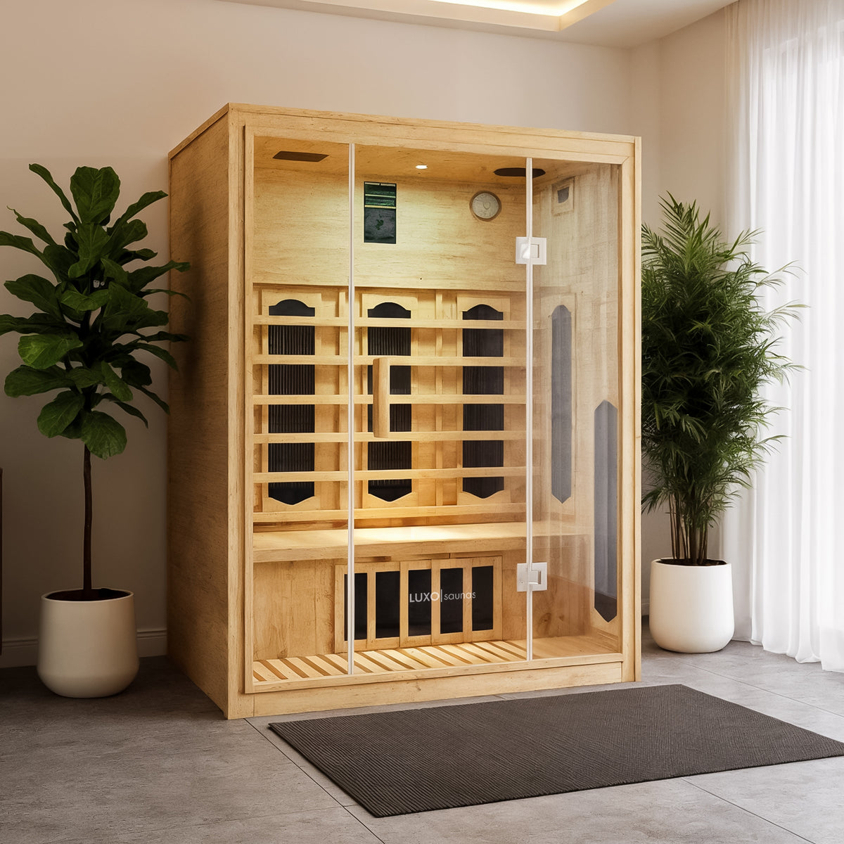 Helle 2-Person Hybrid Infrared Indoor Home Sauna: Light-toned wood, glass doors, built-in heating panels, seating bench, digital control panel, clock. Flanked by plants, spa-like ambiance.