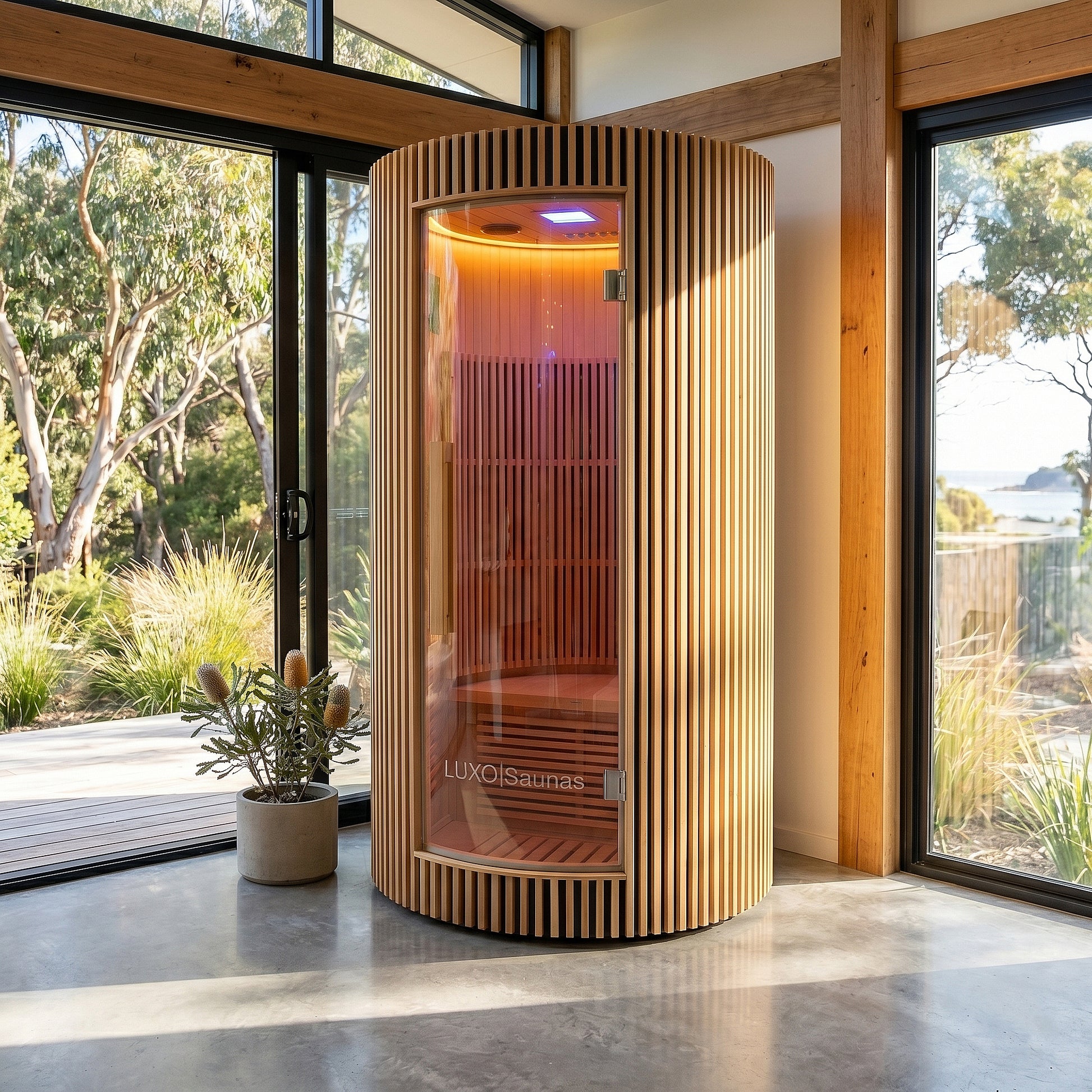 Modern cylindrical sauna in a sunlit contemporary room
