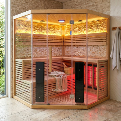 Corner infrared sauna installed in a modern room with towels and a spa-like setup.