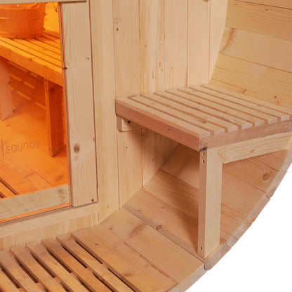 Luola 2 Person Pine Outdoor Barrel Sauna & Wood Stove, showcasing a curved wooden exterior, glass door, fold-down bench, and amber-lit interior with a wooden bench and traditional sauna bucket.