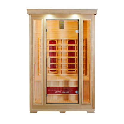 Taavi 2 Person Ceramic Infrared Indoor Home Sauna with light-toned wood, full-glass door, and side panels. Features a bench, infrared heating panels, recessed lights, and Luxo branding on the front.
