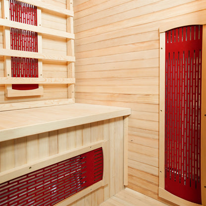 Taavi 2 Person Ceramic Infrared Indoor Home Sauna with light wood paneling, red infrared heating panels, and a bench, designed for relaxation and detoxification in a compact, home-friendly design.