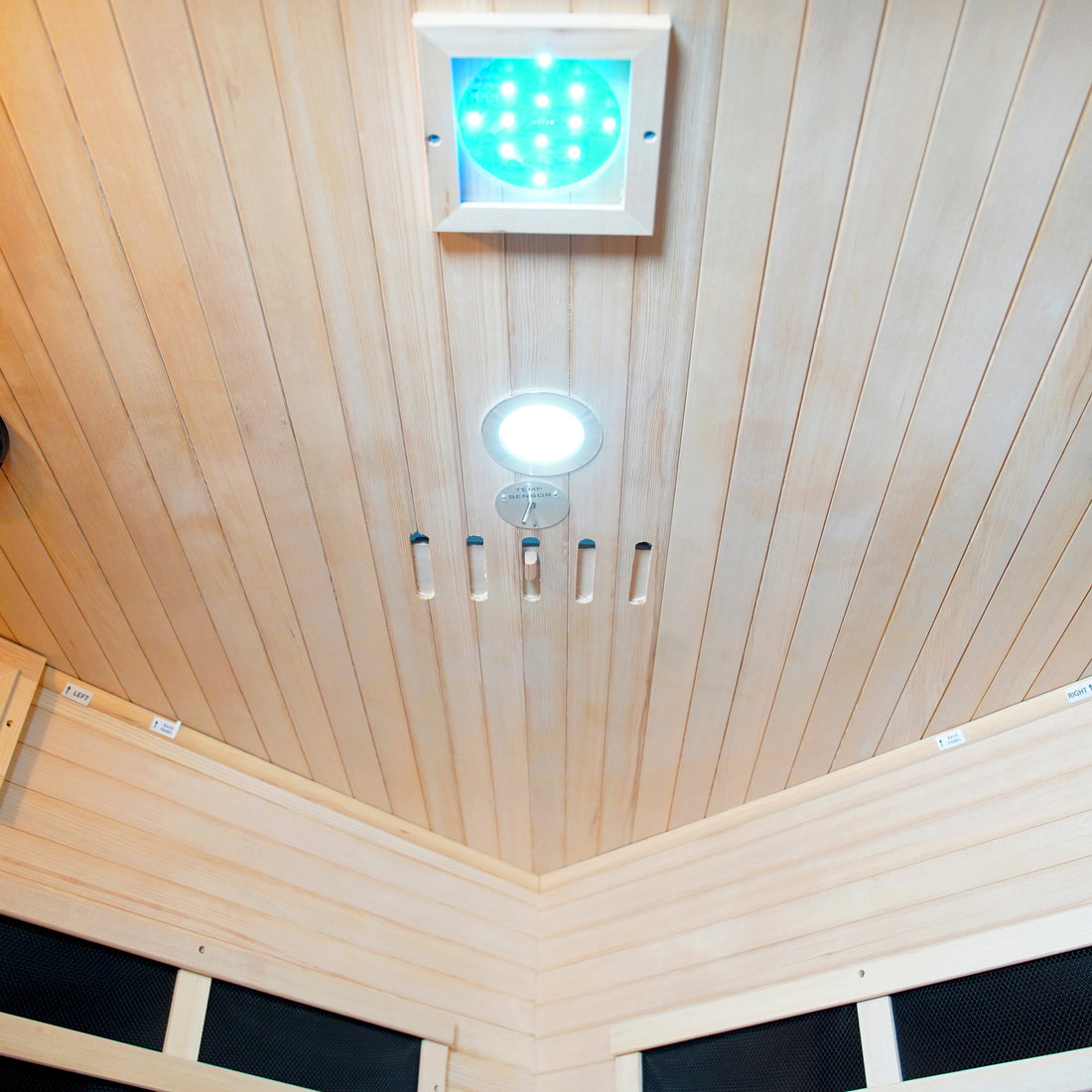 Taavi 4 Person Corner Carbon Fibre Infrared Indoor Sauna ceiling with wood paneling, LED chromotherapy panel, downlight, temperature sensor, and vent slots, showcasing its functional and stylish interior design.