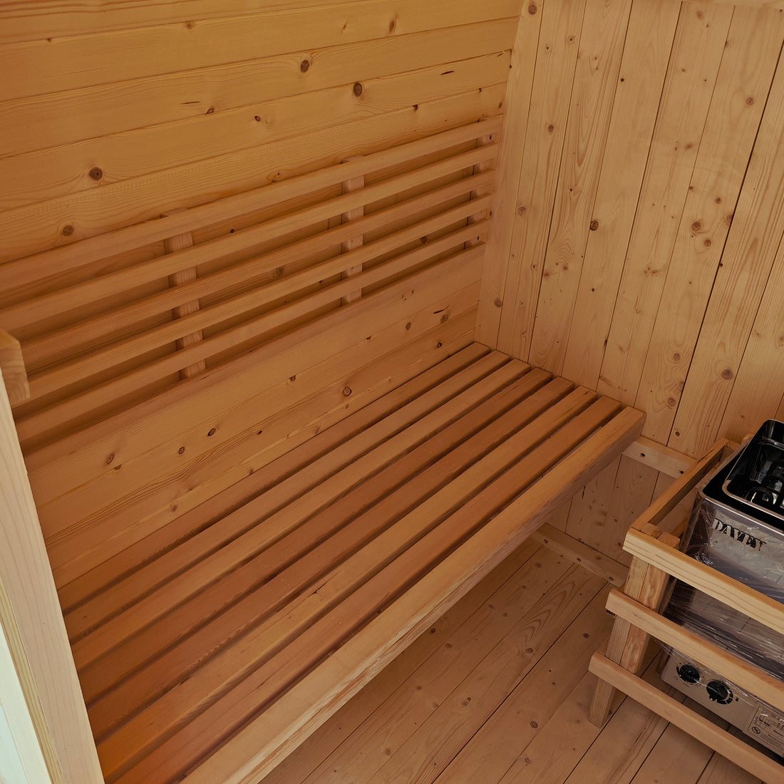 Inside the Tarni 2-Person Finnish Outdoor Sauna – Fir Wood, showcasing slatted wooden benches, wood-paneled walls, and an electric heater, all designed for authentic sauna relaxation.