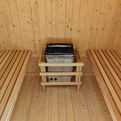 The Tarni 2-Person Finnish Outdoor Sauna – Fir Wood features twin slatted benches and an electric heater with a protective guard, set in a light-colored wood-paneled interior.