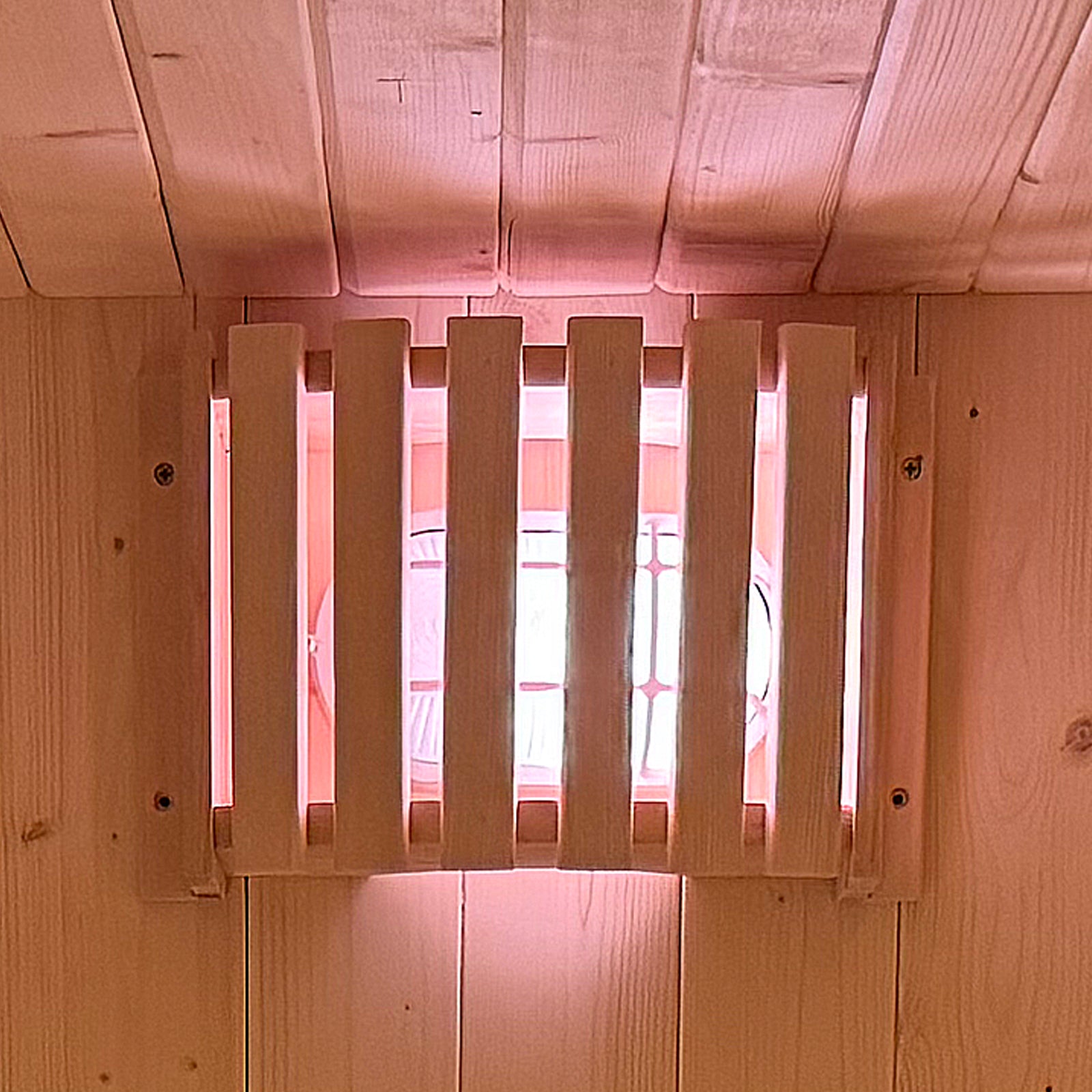 Tarni 2-Person Finnish Outdoor Sauna – Fir Wood, showcasing a wooden-paneled interior with a built-in light fixture protected by vertical wooden slats, typical of rustic cabin aesthetics.