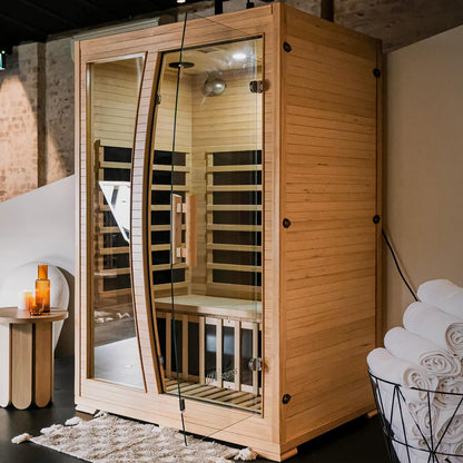 Valo 2-Person Canadian Hemlock Carbon Fibre Home Sauna Cabin with glass doors, showcasing a wooden structure made from durable Canadian Hemlock, designed for indoor use with infrared heating panels.