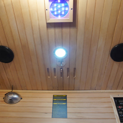 Valo 2-Person Canadian Hemlock Carbon Fibre Home Sauna Cabin featuring a sleek black control panel and wooden interior, illuminated by an LED light, offering a luxurious, energy-efficient sauna experience.