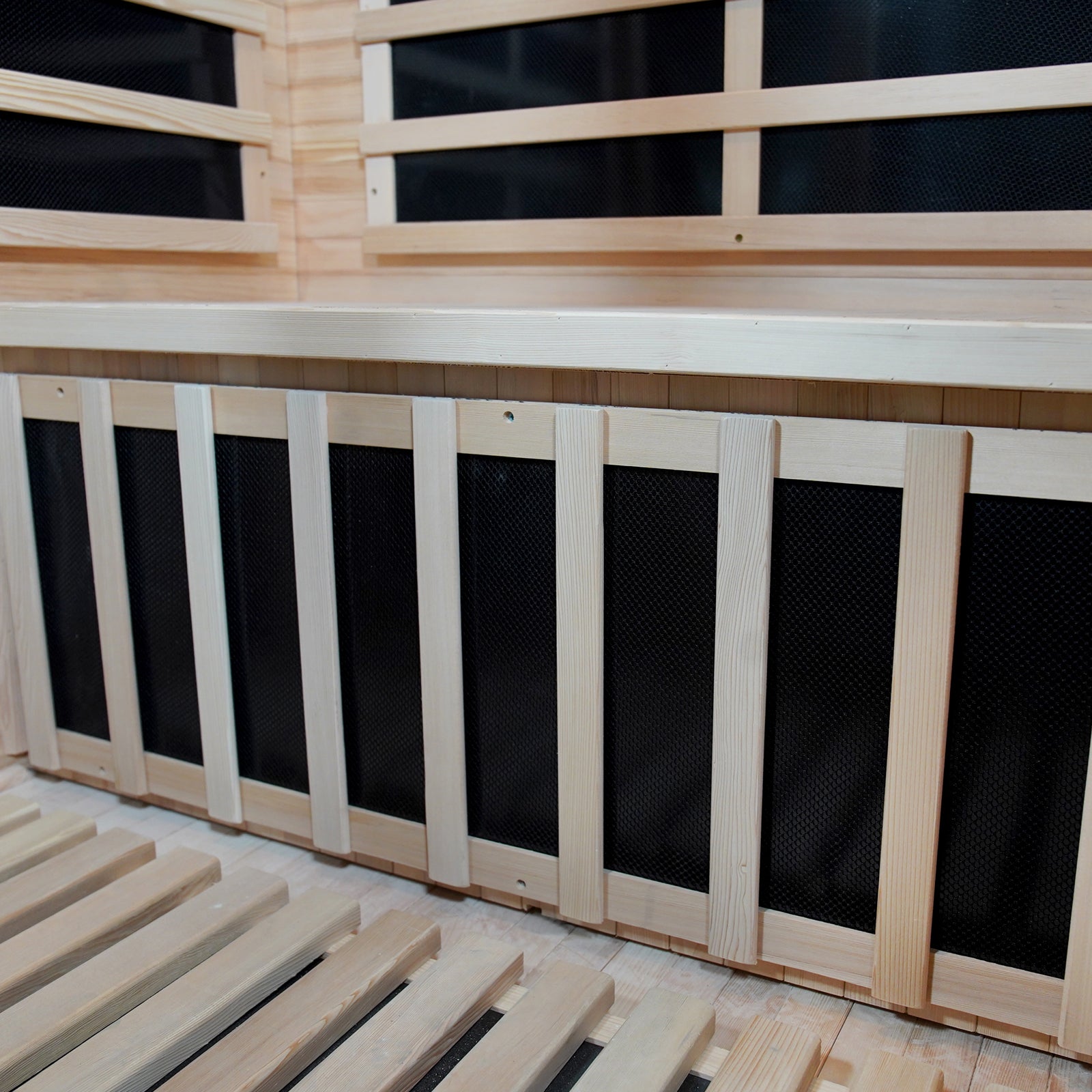Valo 2-Person Canadian Hemlock Carbon Fibre Home Sauna Cabin with durable wooden structure and black screen panels, showcasing its portable design and intricate woodwork detail for a luxurious sauna experience.
