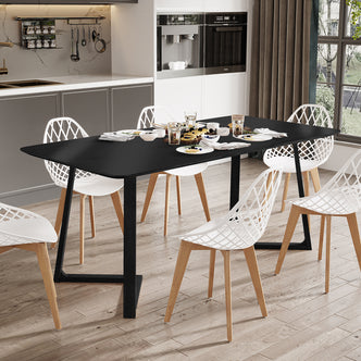 Adelina 180cm Rectangular Hardwood Dining Table Black, set for breakfast with waffles and drinks, surrounded by six white lattice-back chairs, in a modern, minimalist kitchen-dining space.