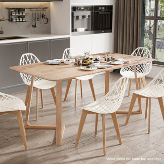 Adelina 180cm Rectangular Hardwood Dining Table Natural with solid wood top and legs, surrounded by white lattice chairs, set for a casual meal in a bright, modern kitchen-dining area.