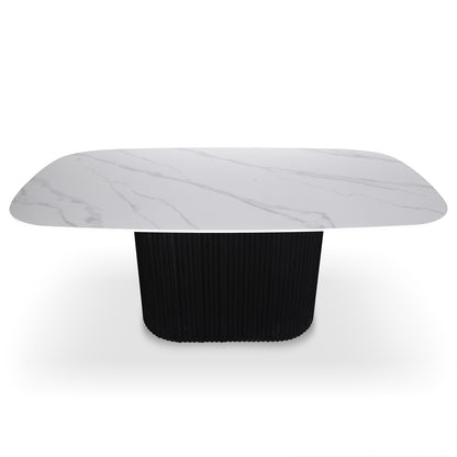 Aeris 180cm Marble Look Dining Table With Wood Base in Black features a white marble-look top with grey veining and a fluted black pedestal base, offering modern elegance and practicality.