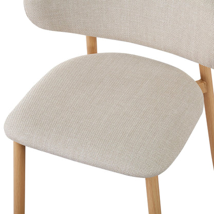 Close-up of the Audrey Curved Fabric Dining Chair Set of 2 in Beige, showcasing the light-beige upholstered seat and backrest with natural-wood legs, highlighting its modern design and plush comfort.