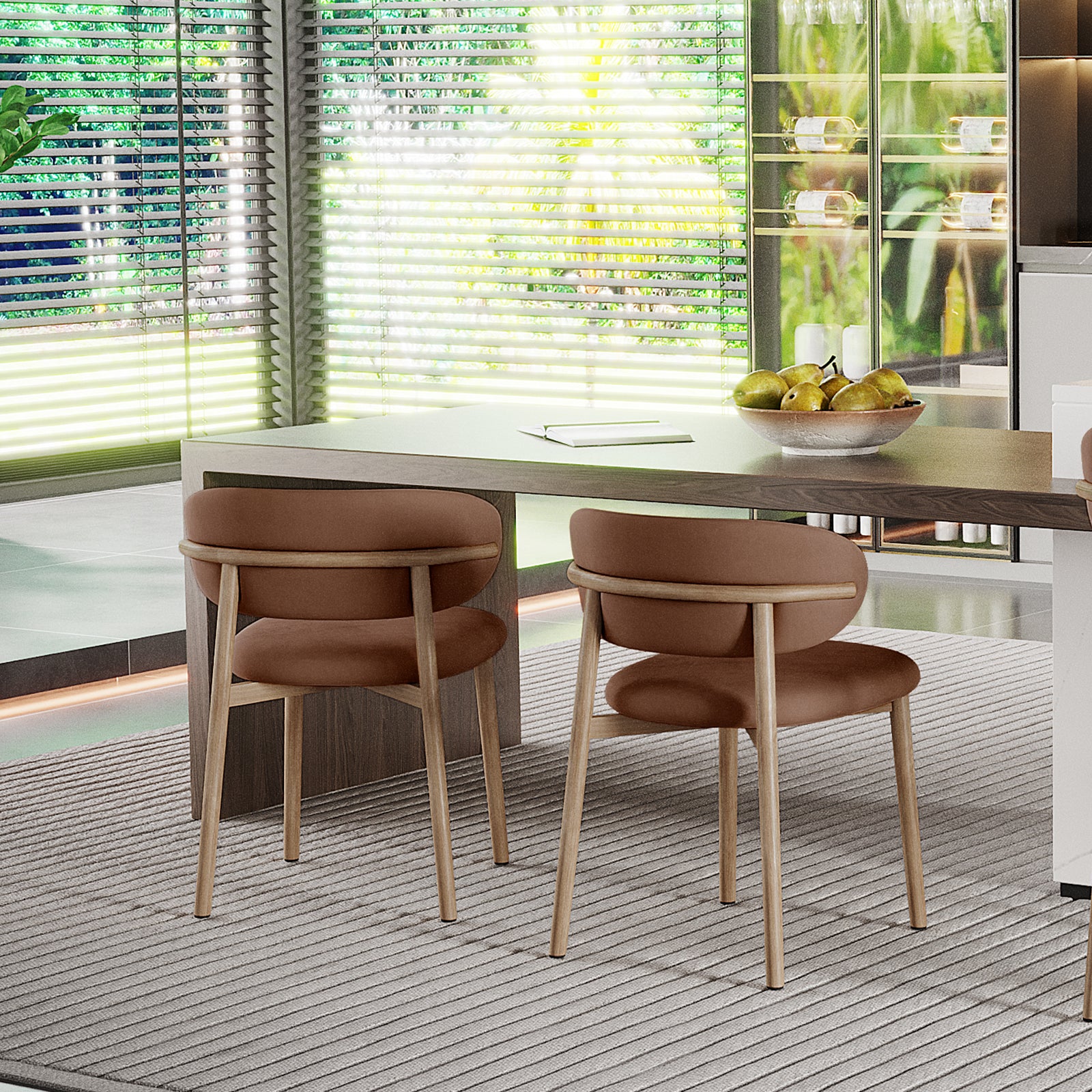 Audrey Fabric Dining Chair Mocha Mouses Set of 2 in a dining nook, featuring light-wood chairs with rounded cushions at a wooden table, beneath a neutral-tone area rug, framed by large windows.
