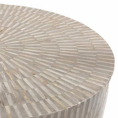 Baltoy 100cm Mother of Pearl Coffee Table in Striped Bone, featuring a round surface with a radial inlay pattern. The light-neutral strips form concentric rings, creating a sunburst mosaic effect.