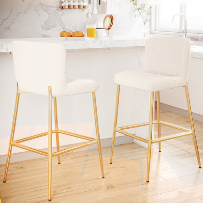 Bernie High Back Boucle Bar Stool Set of 2 in White, featuring plush off-white upholstered seats with gold-finished legs and a square footrest, accentuates a modern kitchen's marble and wood elements.