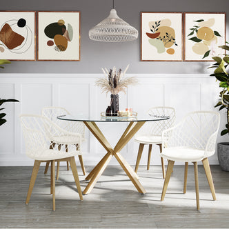Caesar Beech Dining Chair Set of 4 in Cream White, featuring lattice-style backs and wooden legs, surrounds a round glass-top table with decorative elements, enhancing the modern dining nook's elegance.
